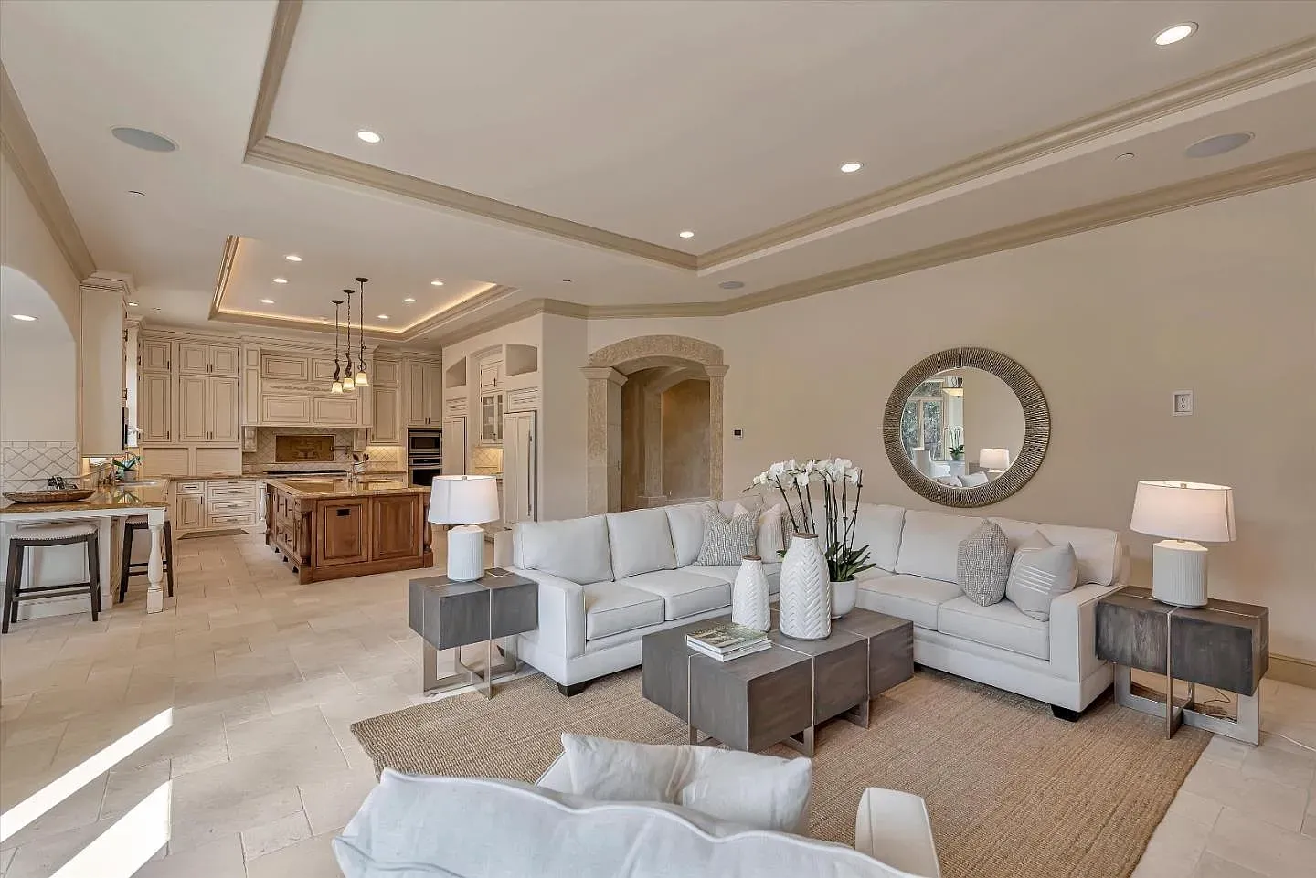 Open living room, lots of light on the travertine. Comfortable without trying hard.