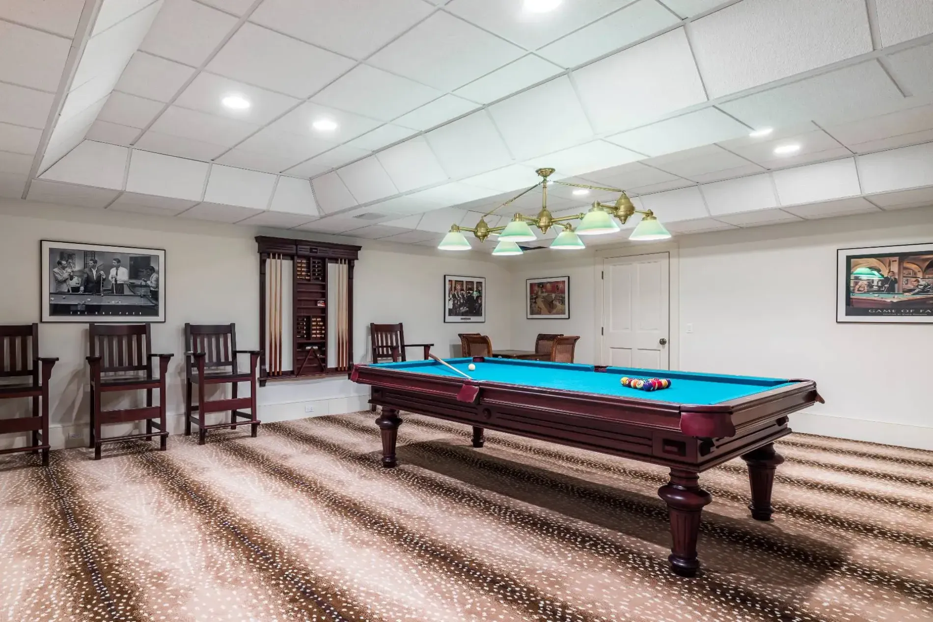 Blue felt pool table stealing the show. Cozy basement vibes, good for winter.