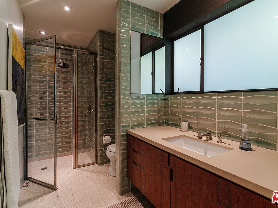 Aqua wavy tiles are doing the whole spa thing.