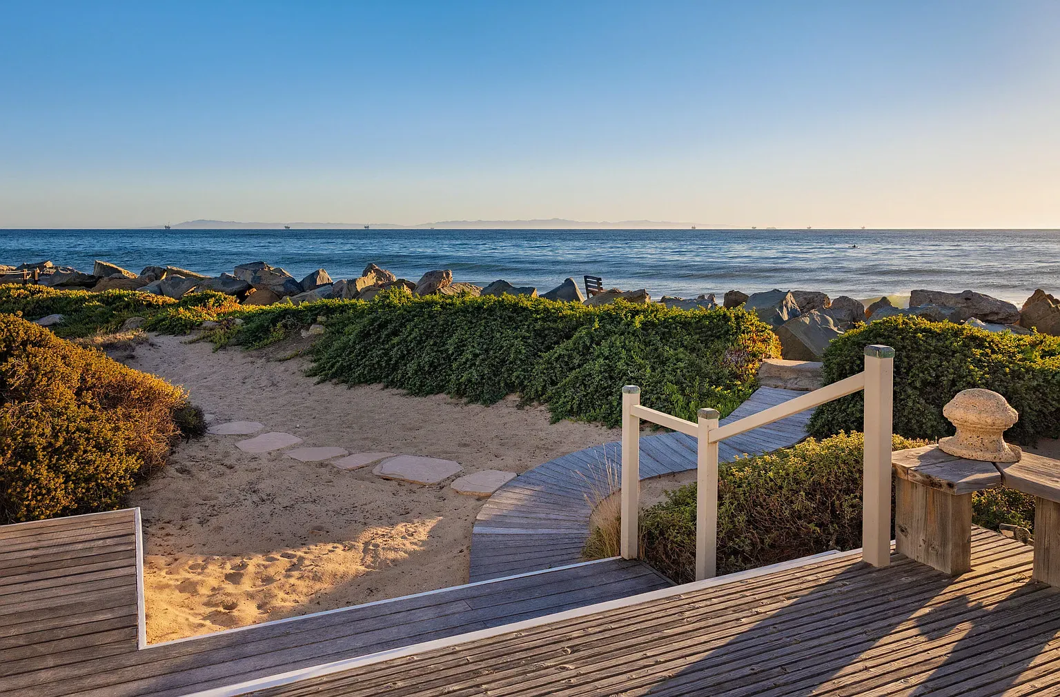 Path straight to the beach. Sand, shrubs, and that deep blue waiting.