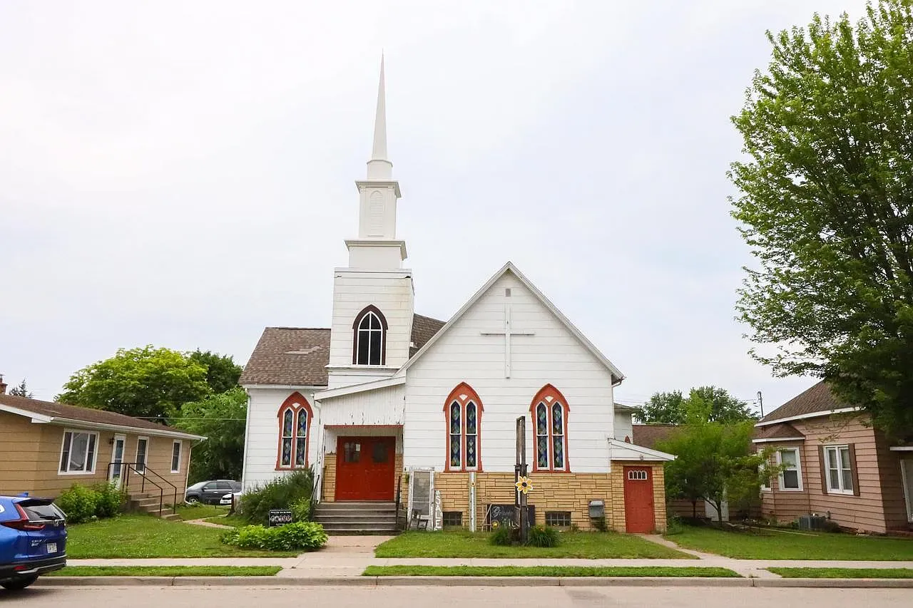 Old church bones with those pointed stained glass windows. Clean white looks crisp.