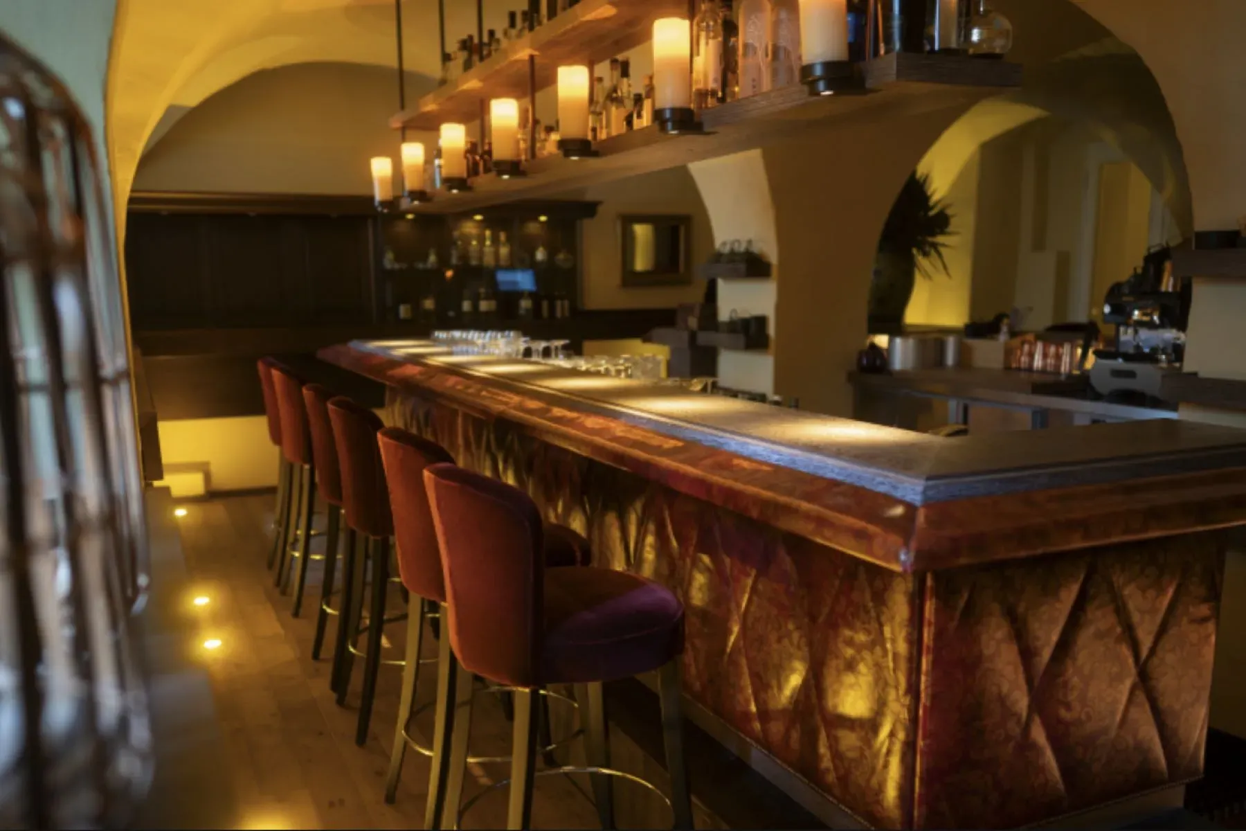 Curved burgundy velvet bar looks dangerously fun. Please hide my credit card.