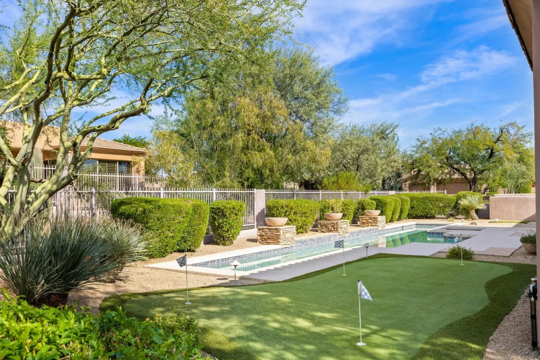 Okay, there's a full-on putting green back here. Flags and everything.
