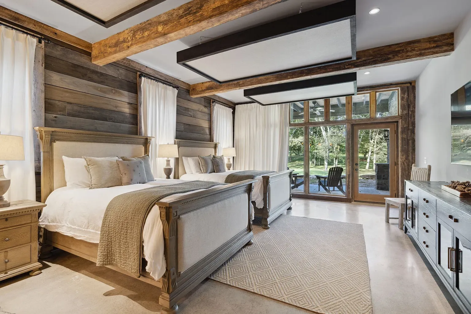 Bedroom beams for days. Wood paneling makes it feel a fancy cabin.