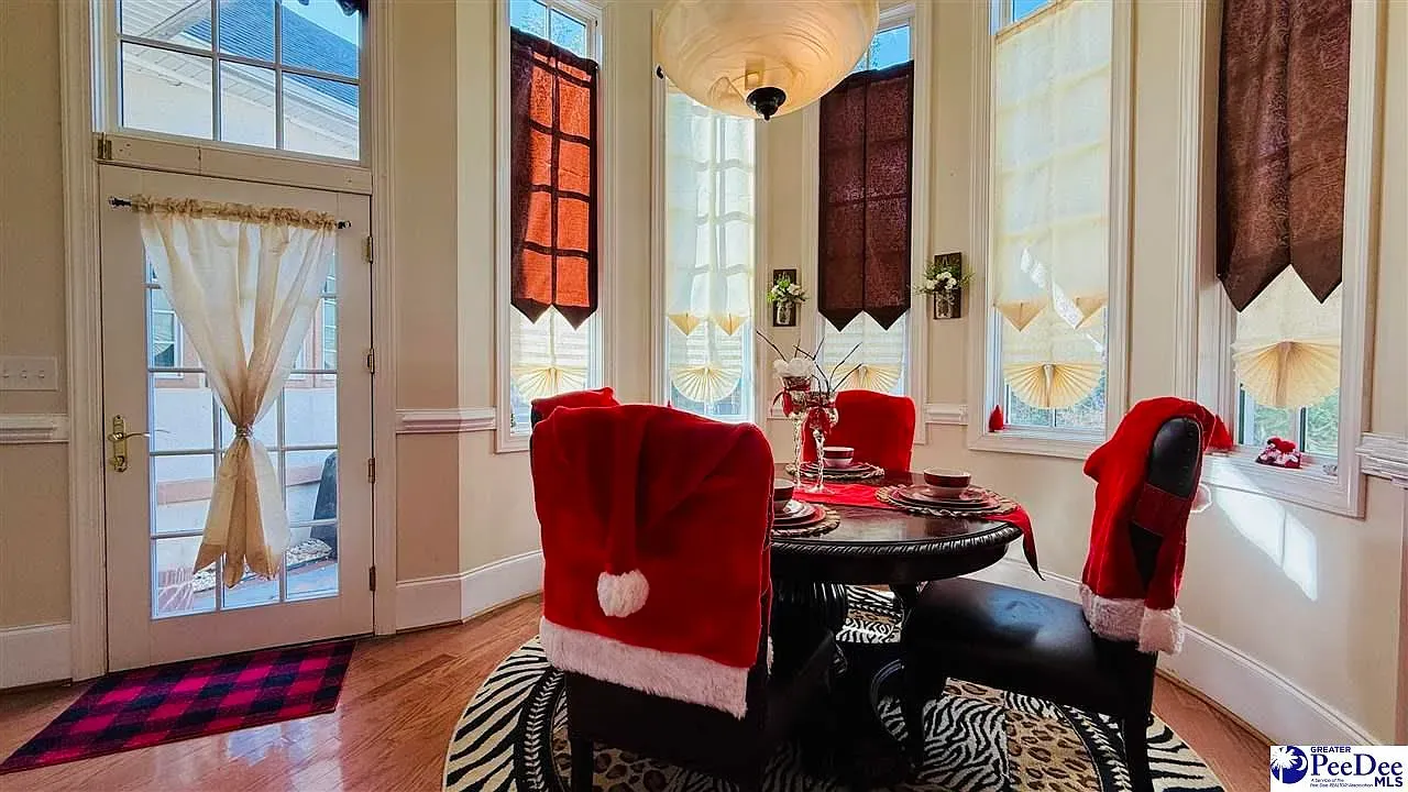 Sunny nook with dramatic maroon drapes. Feels cozy and a little formal.