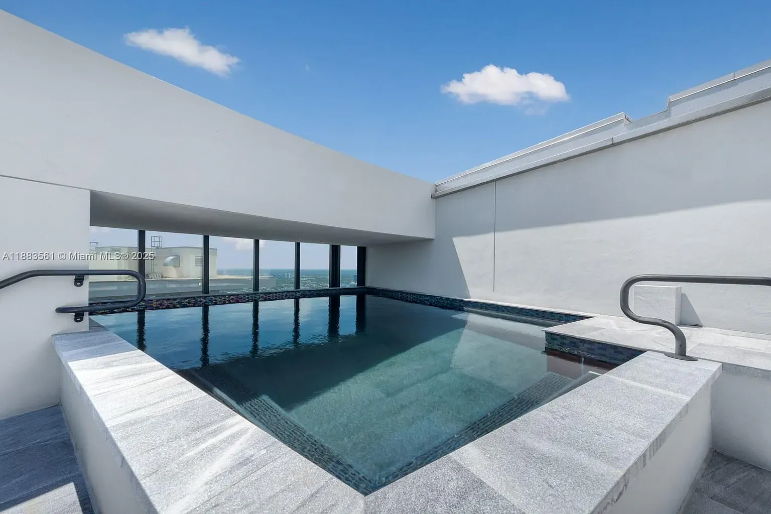 And then, rooftop infinity pool. Clean lines, pale stone, horizon just melts.