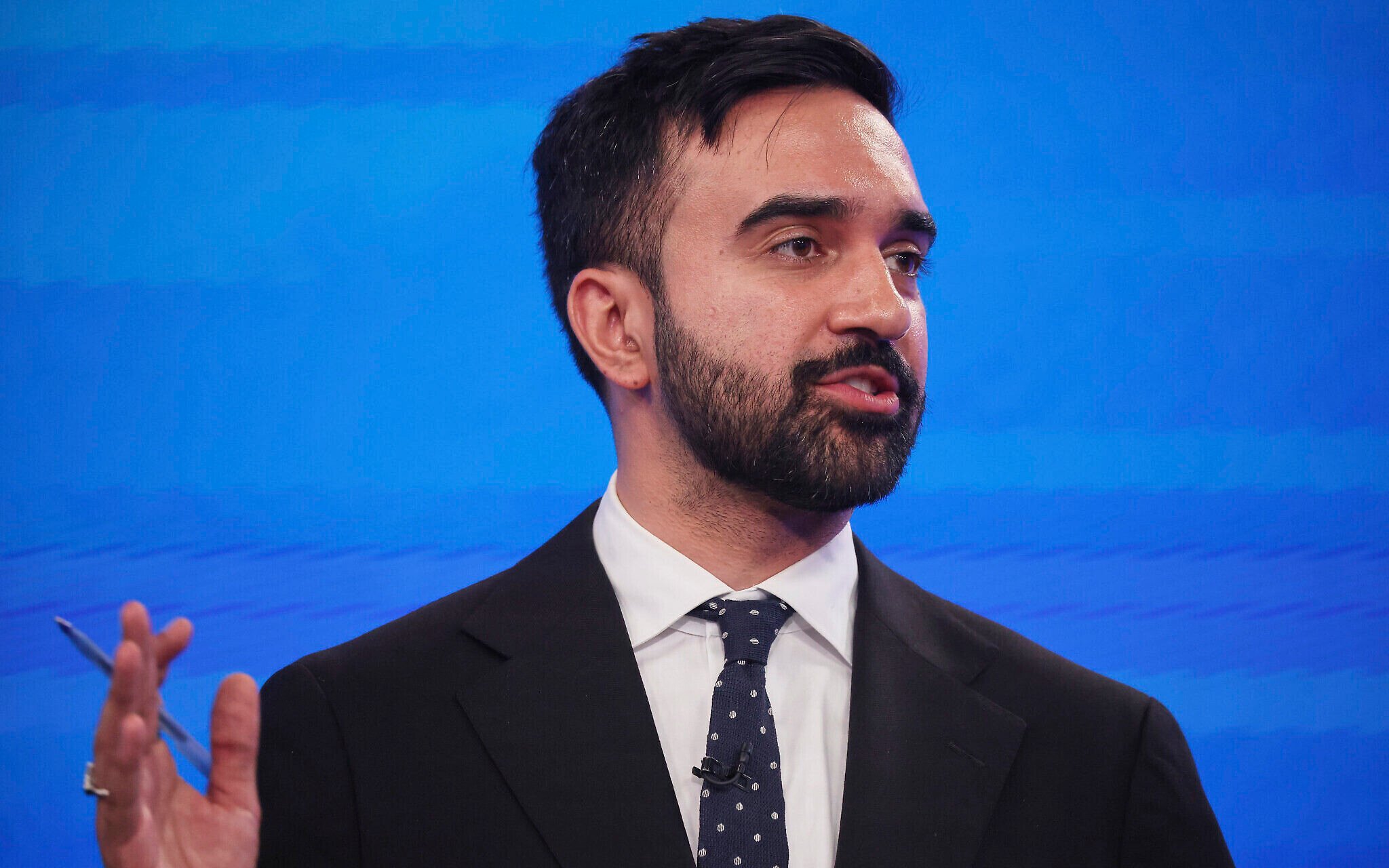 Zohran Mamdani at a podium