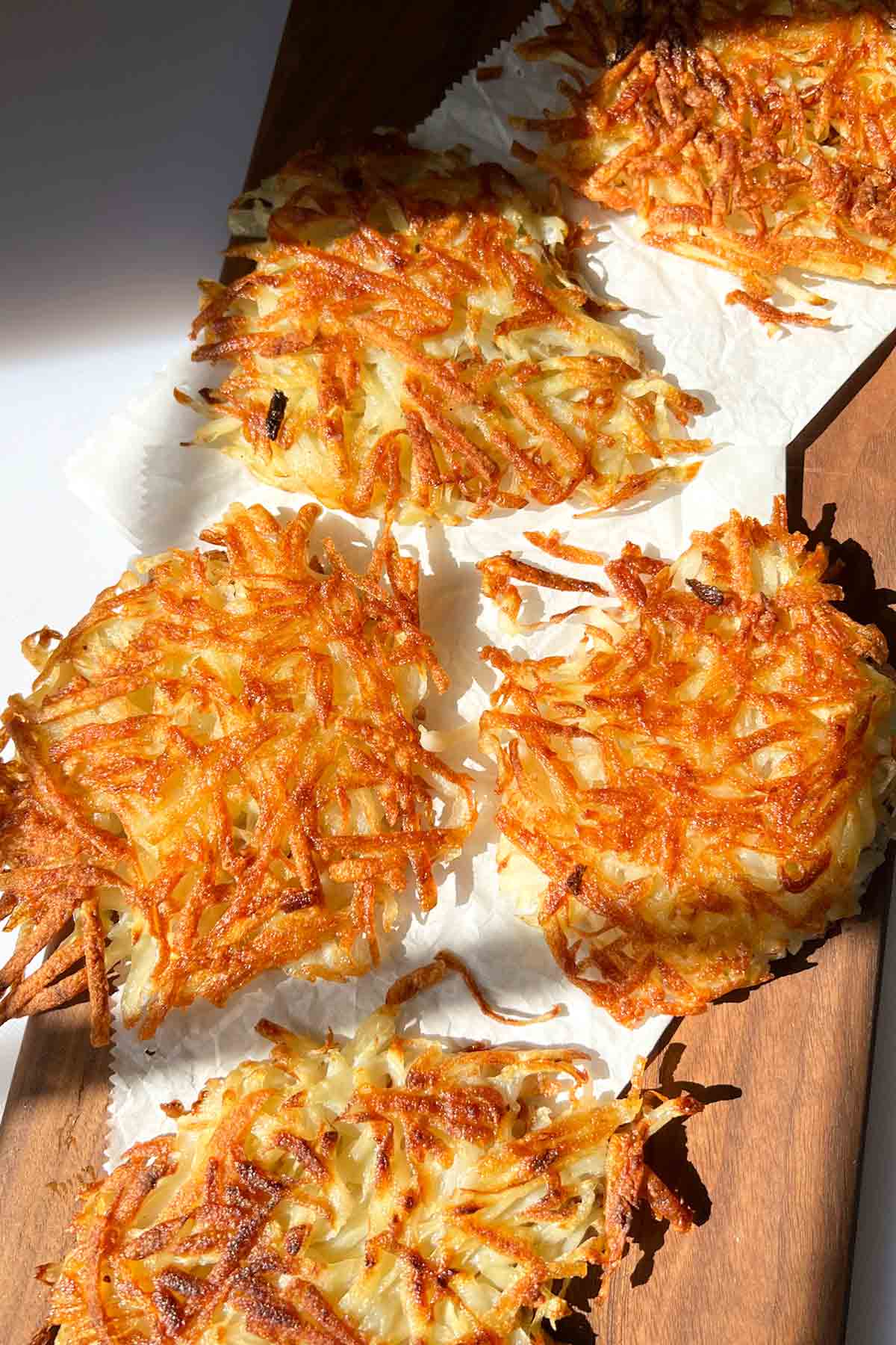 a plate of golden hash browns with crispy edges