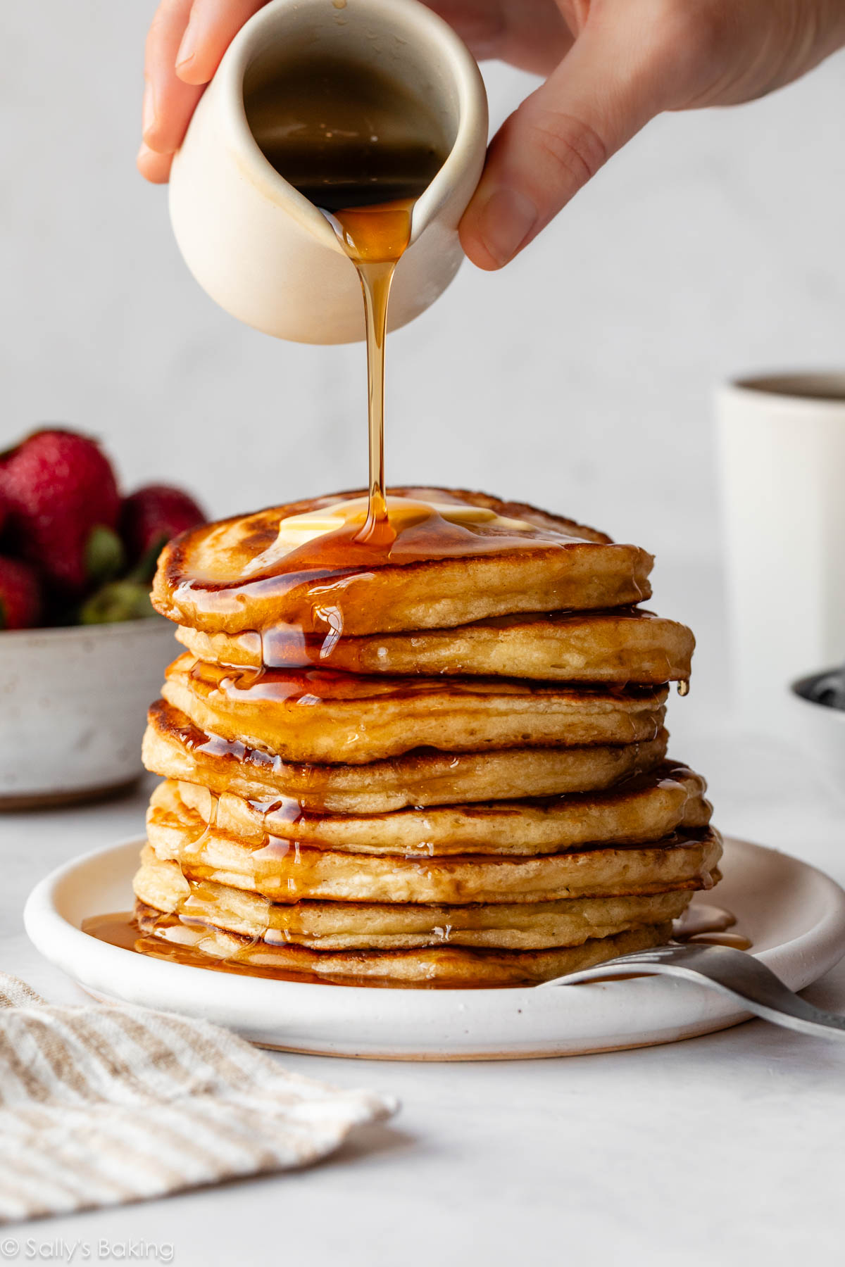 a fluffy stack of pancakes with syrup