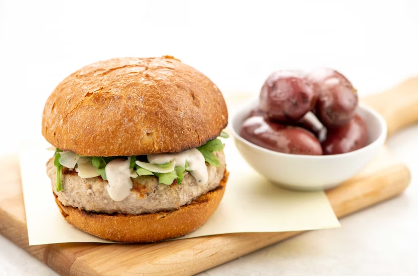 Grilled Caesar Turkey Burger with Arugula and Seasoned Potatoes