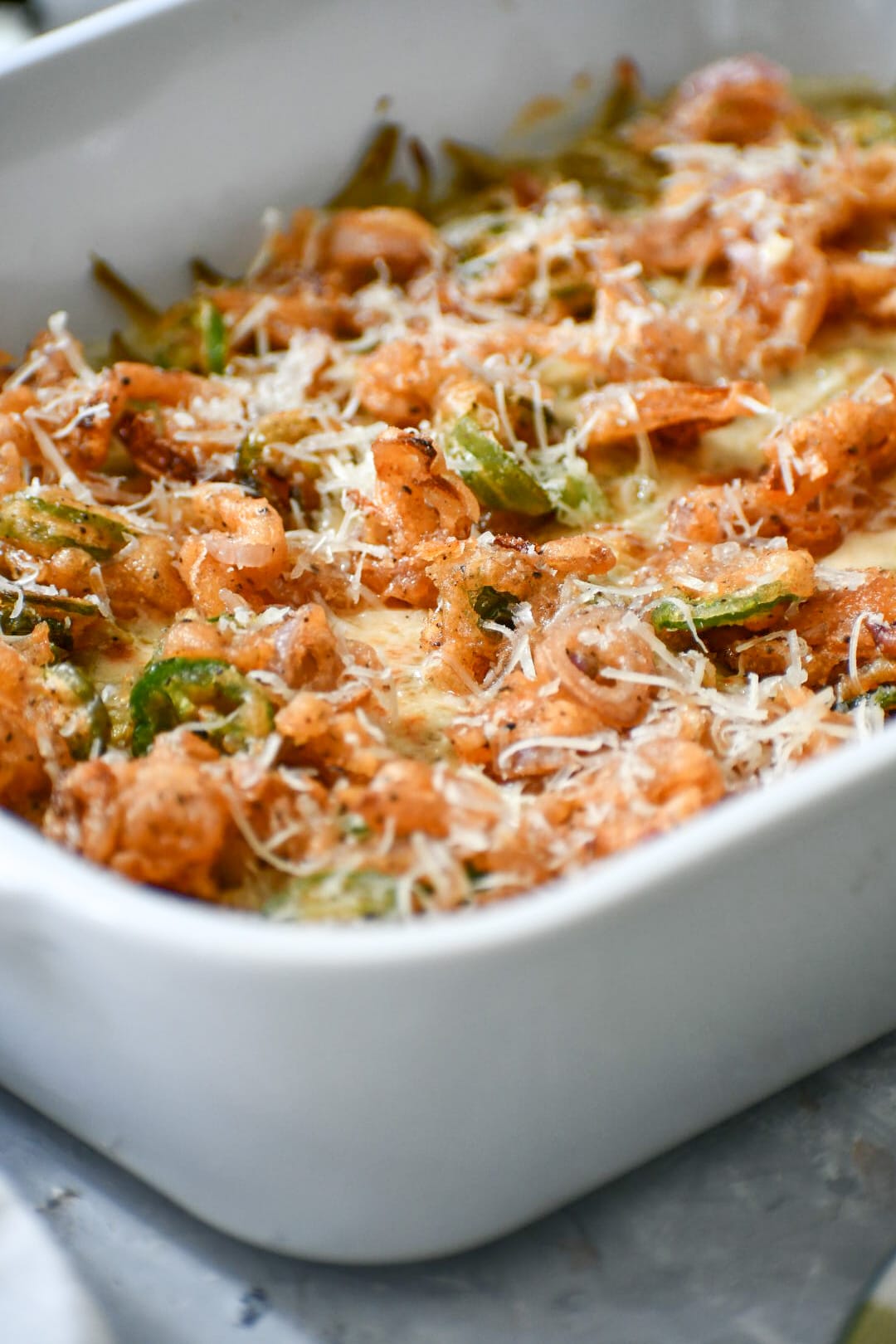 casserole dish with green beans and visible jalapeños