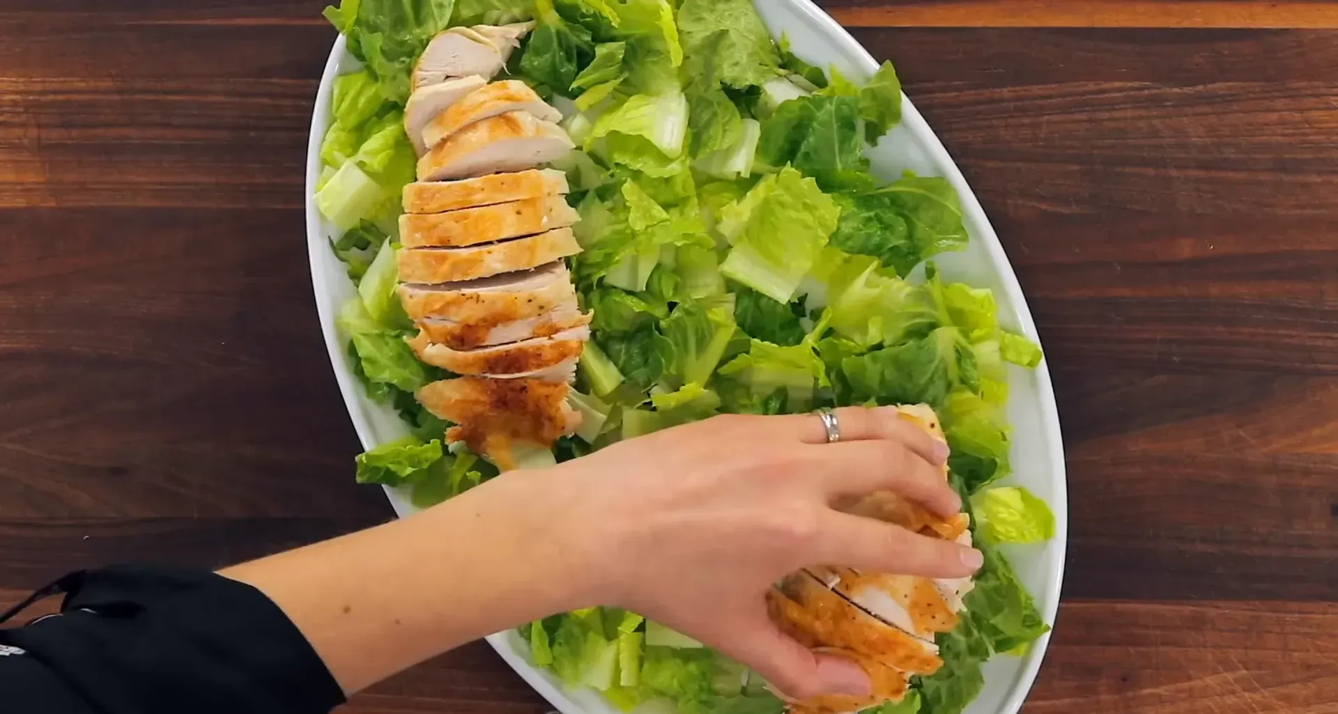 Chicken layered on lettuce.