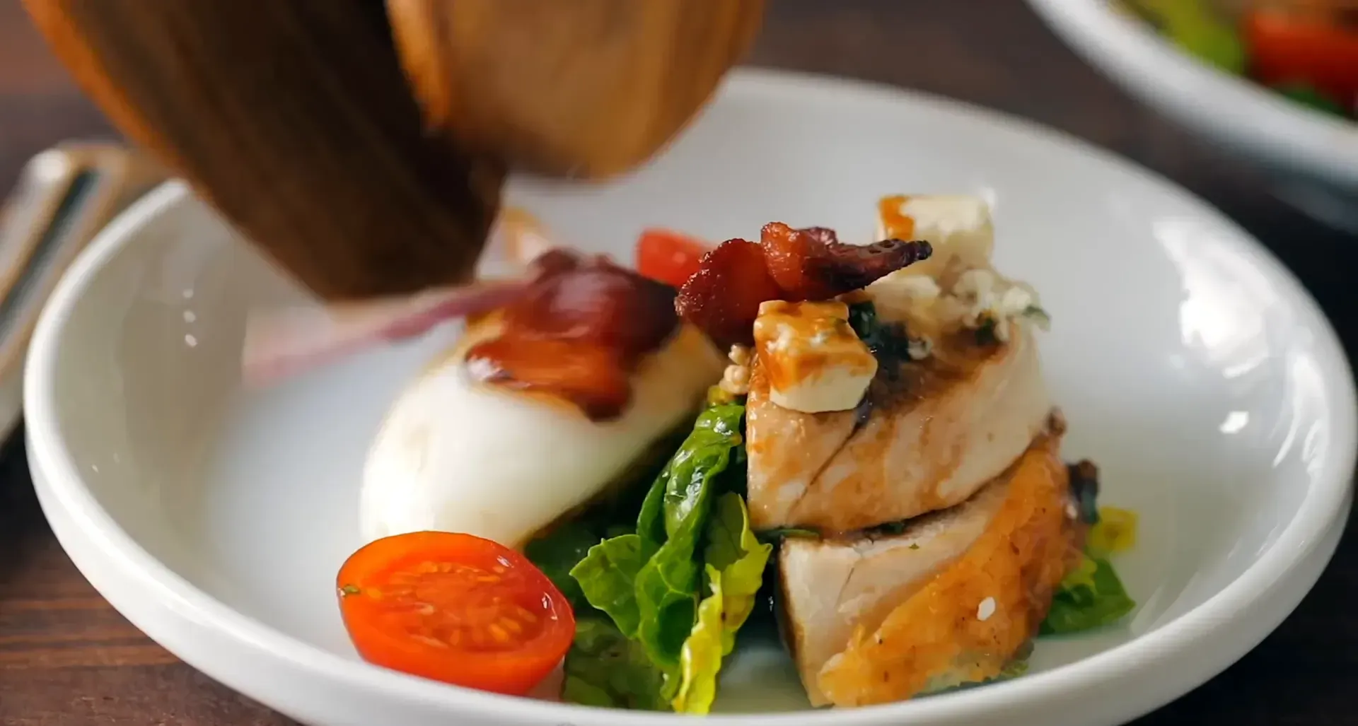 Adding more dressing to the salad.