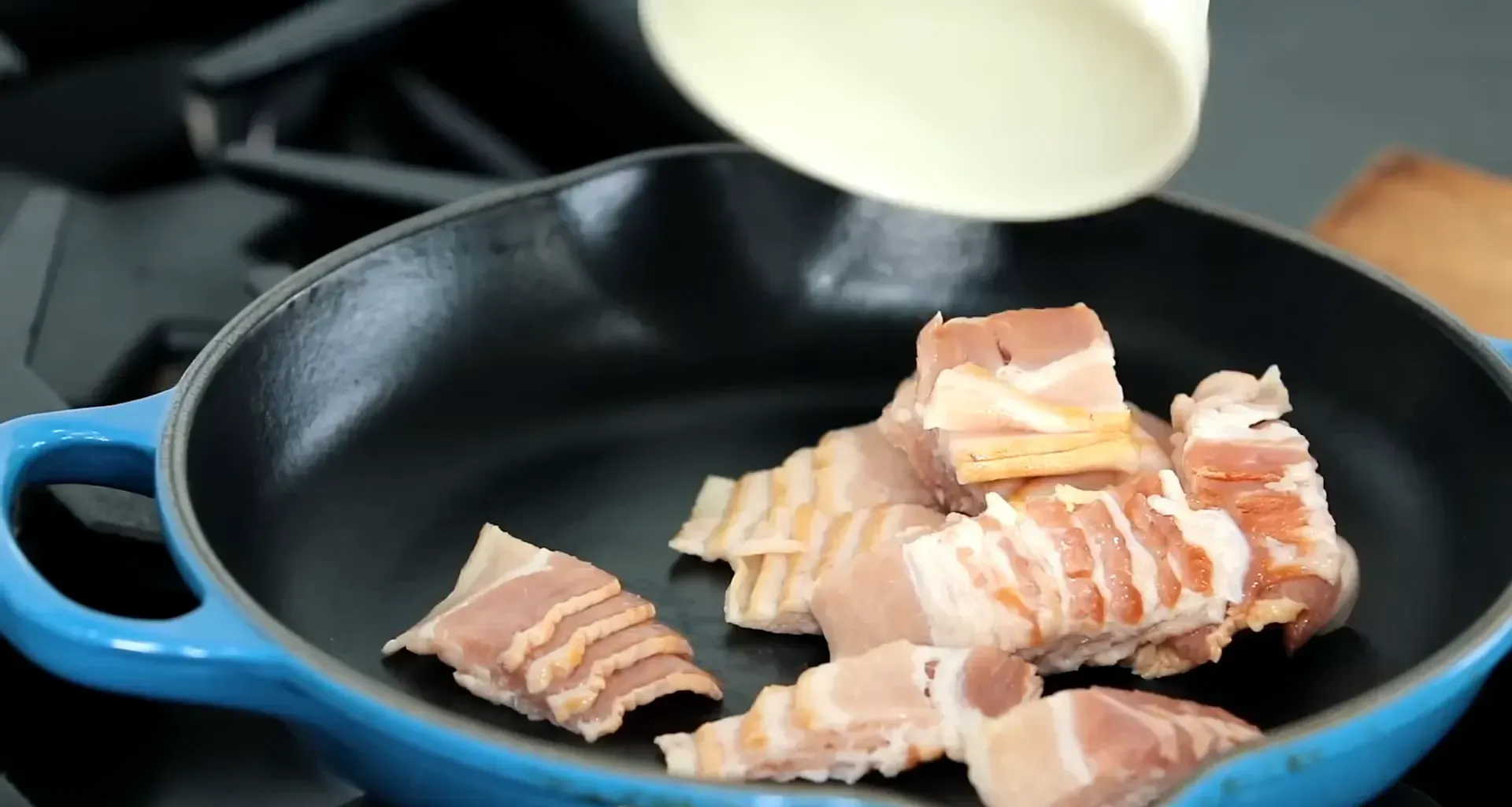 Cooking bacon in a pan.