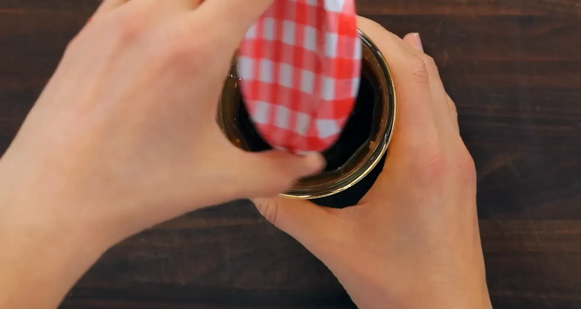 Shaking the dressing in the mason jar.