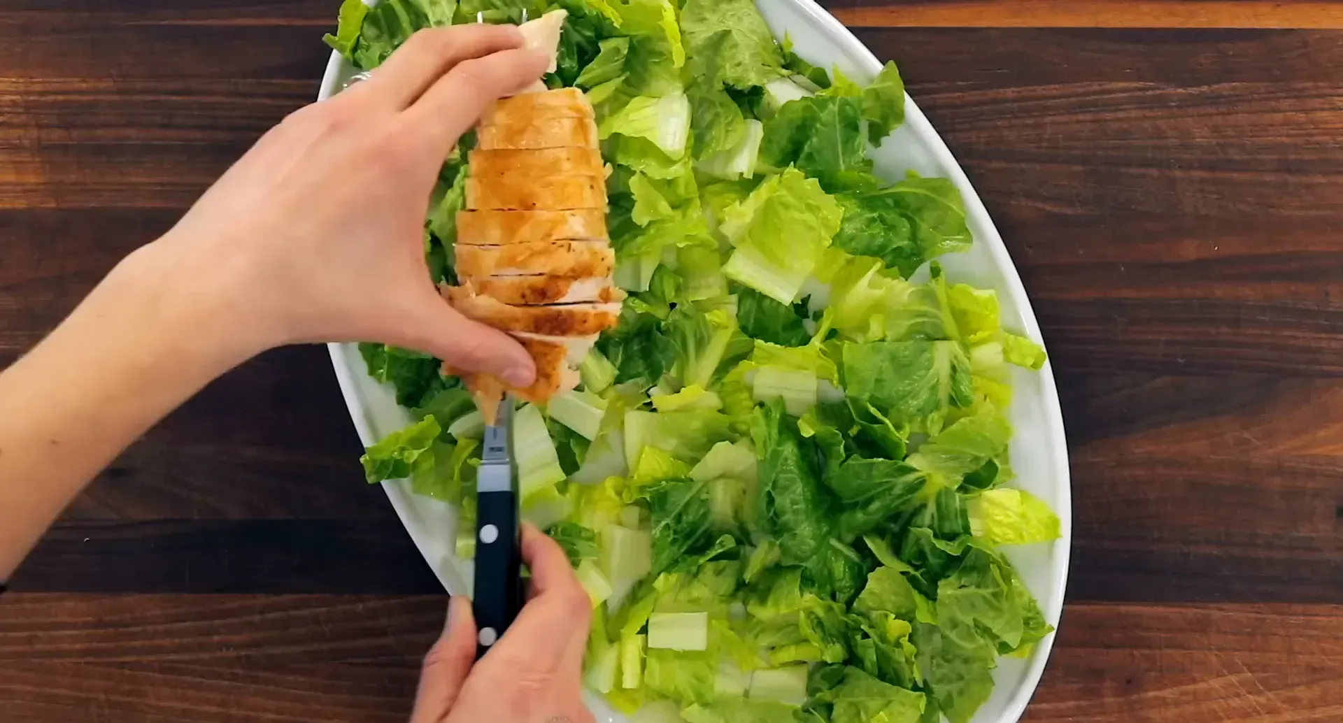 Layering chicken on the salad.