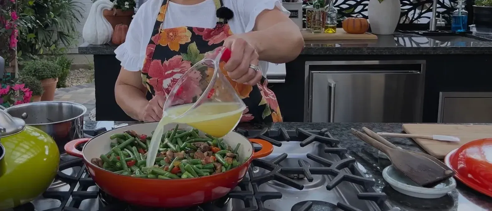 Adding chicken broth to the pan
