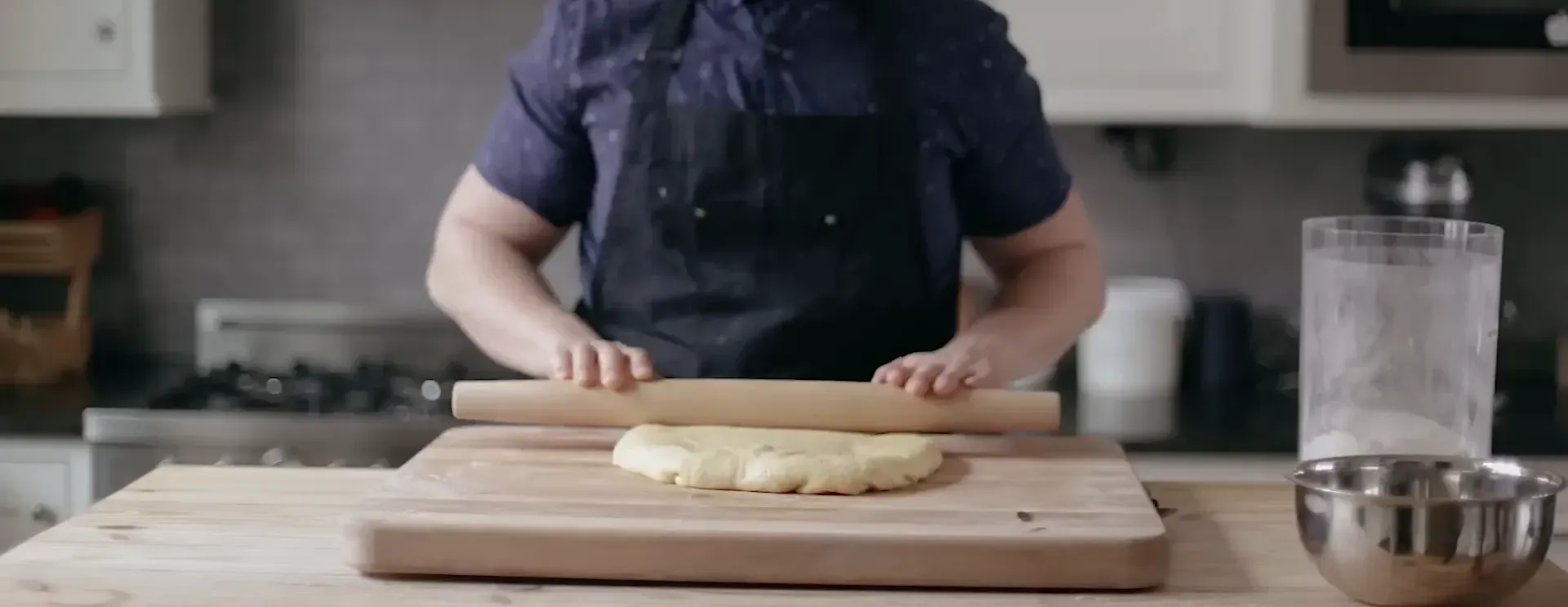 Punching down the risen dough.