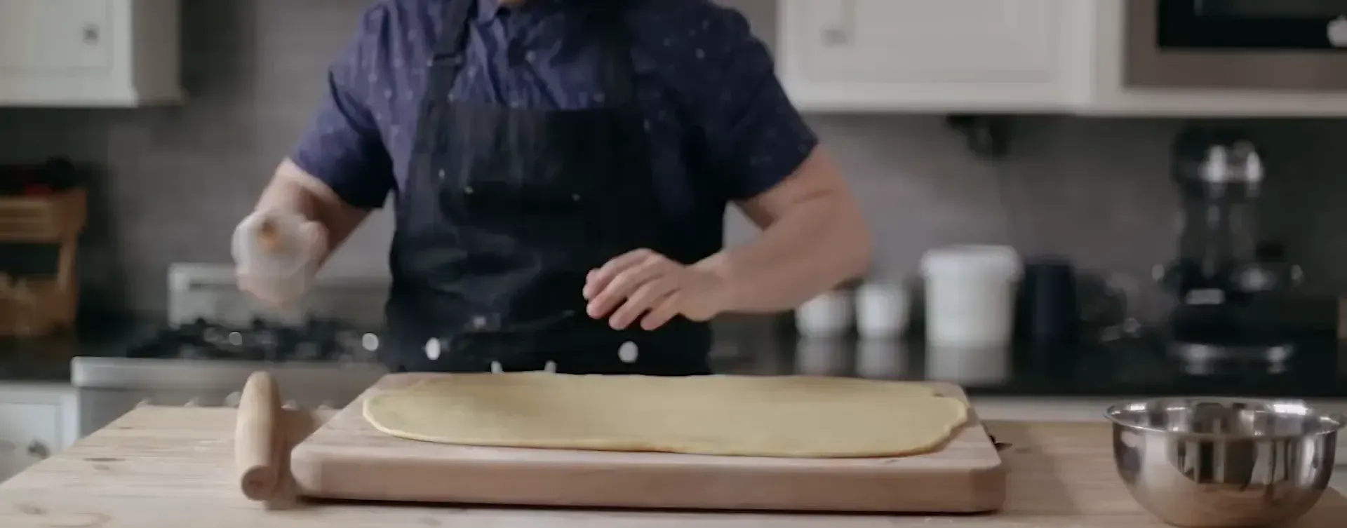 Rolling out the dough into a rectangle.