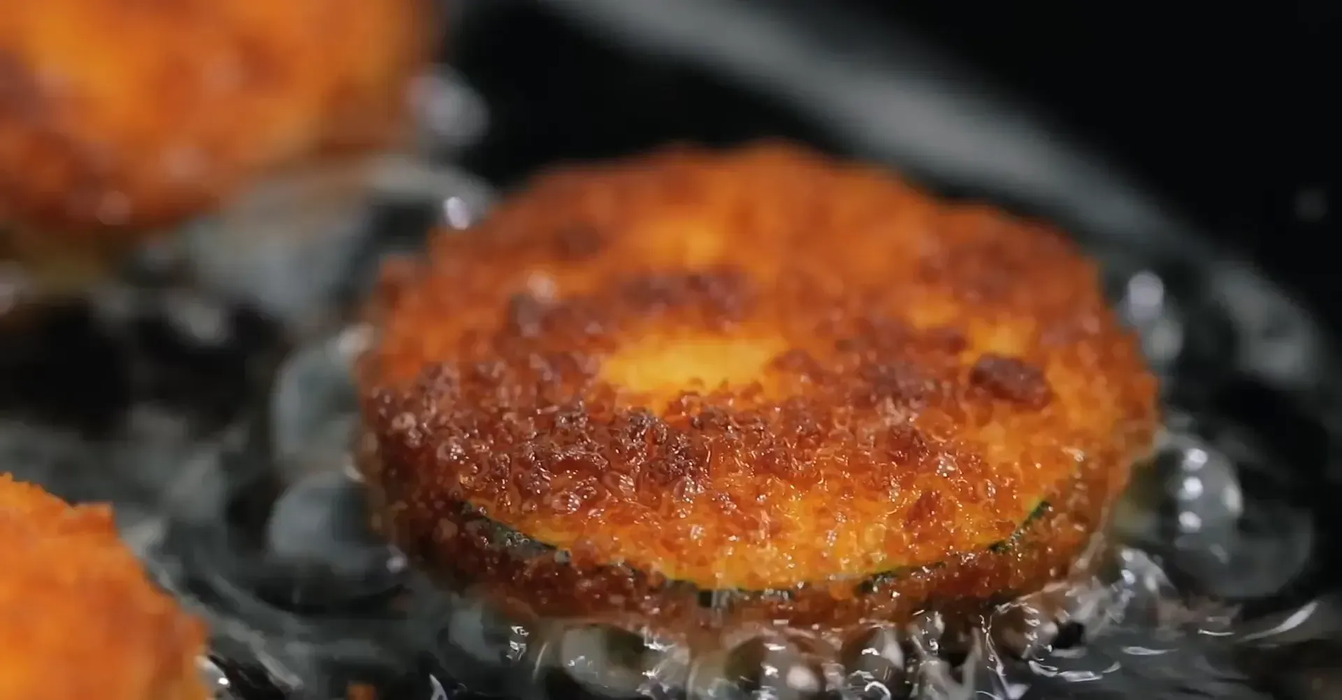 Sprinkling salt on cooked zucchini.