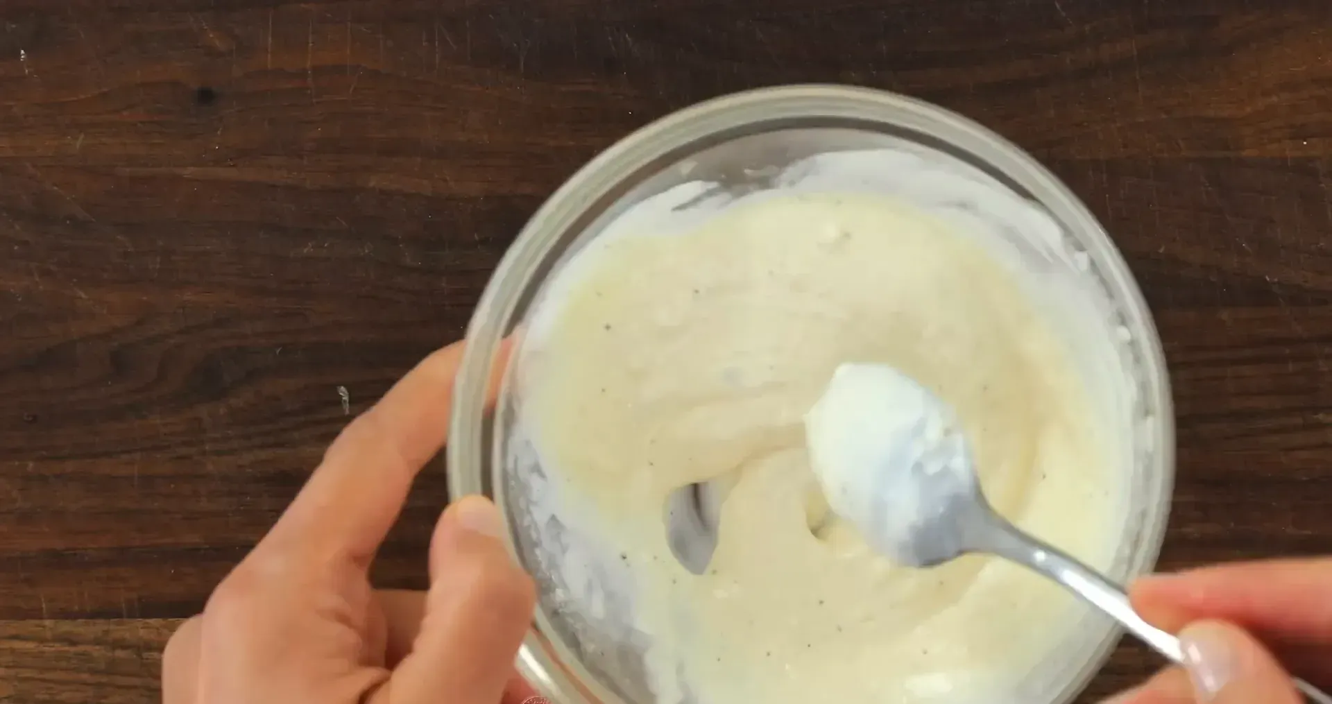 Stirring garlic aioli together.