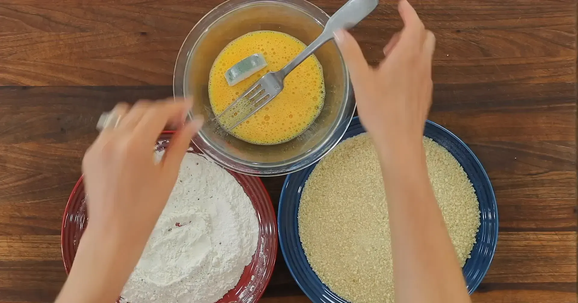 Dipping zucchini in egg.