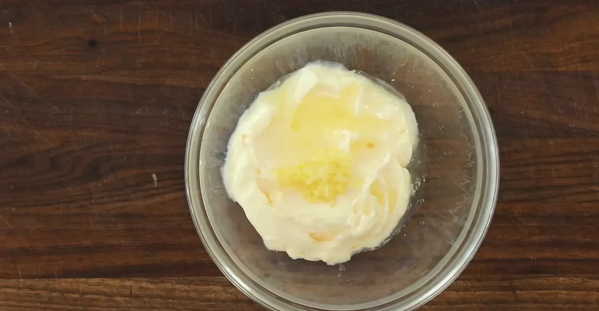 Adding salt and pepper to the aioli.