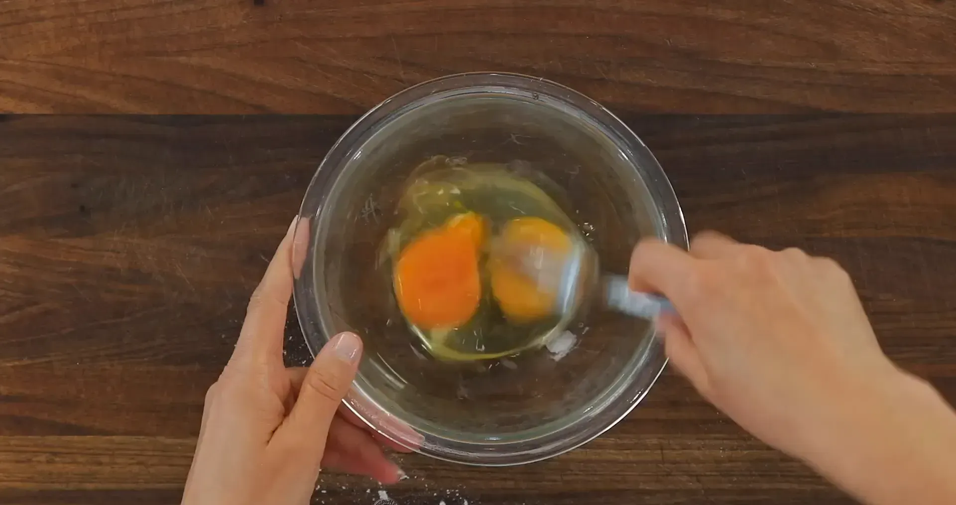 Beating the eggs in a bowl.