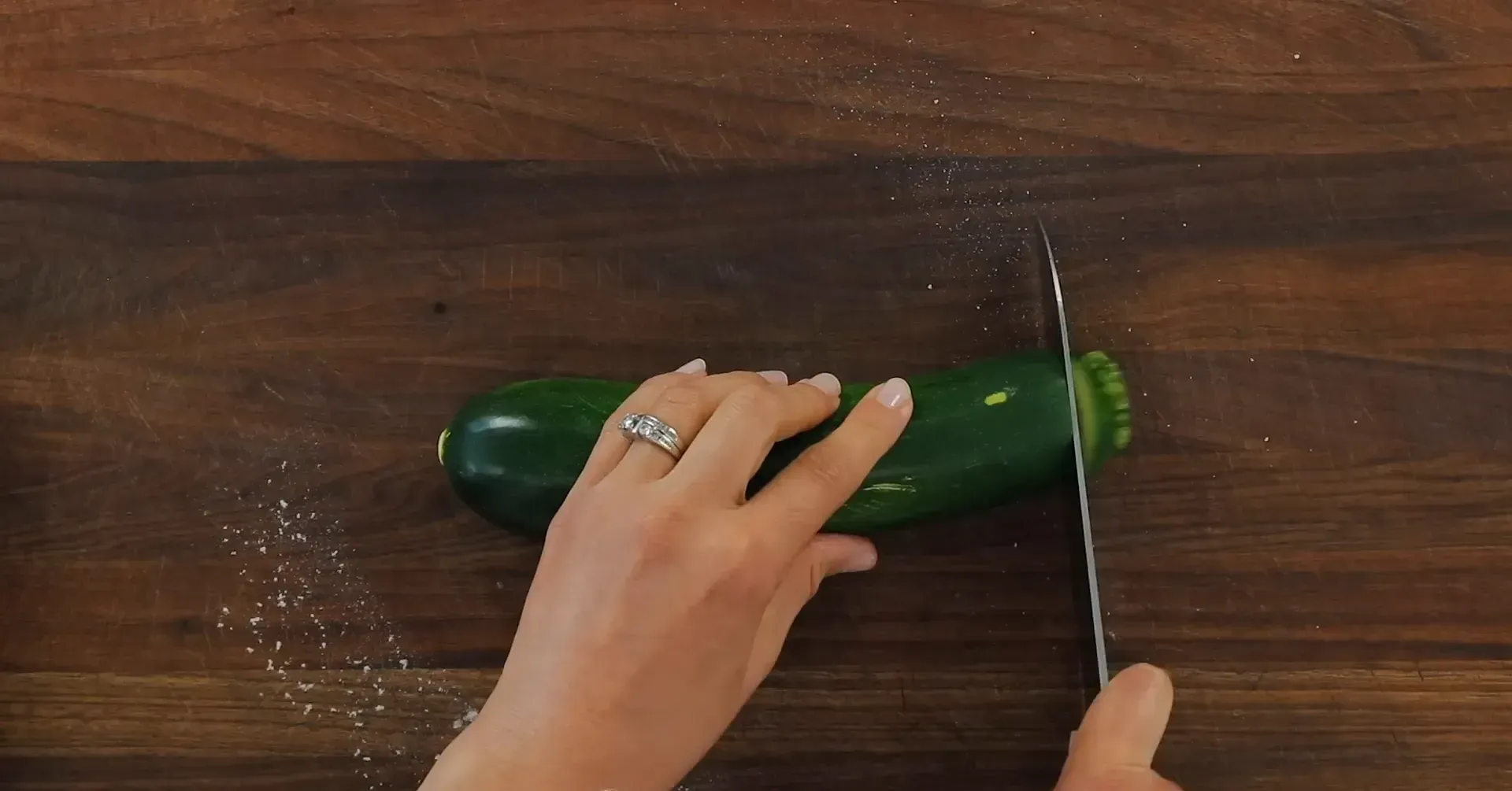 Slicing zucchini into rounds.