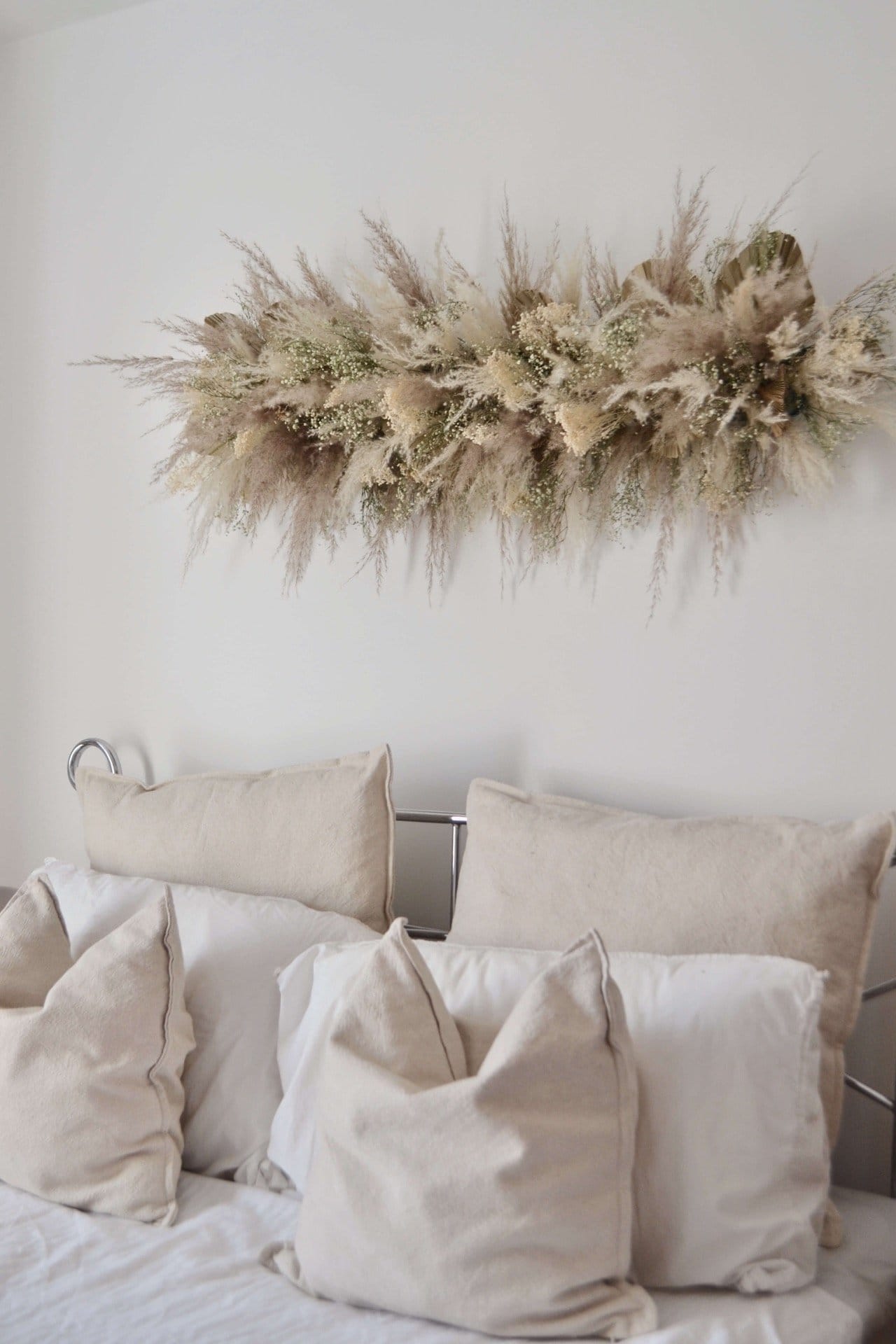 Bedroom wall with dried flower installation