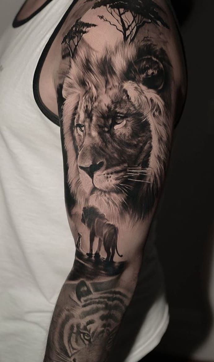 an upper arm tattoo with portrait lion