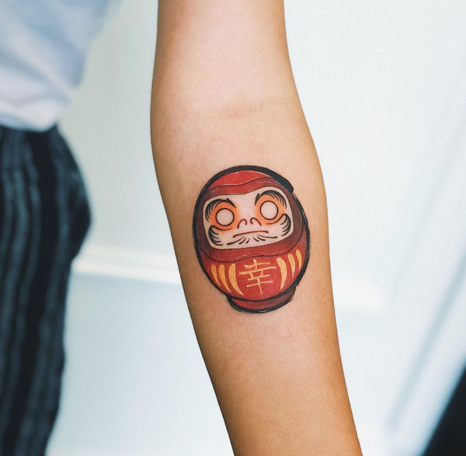 a small Japanese Daruma doll tattoo design