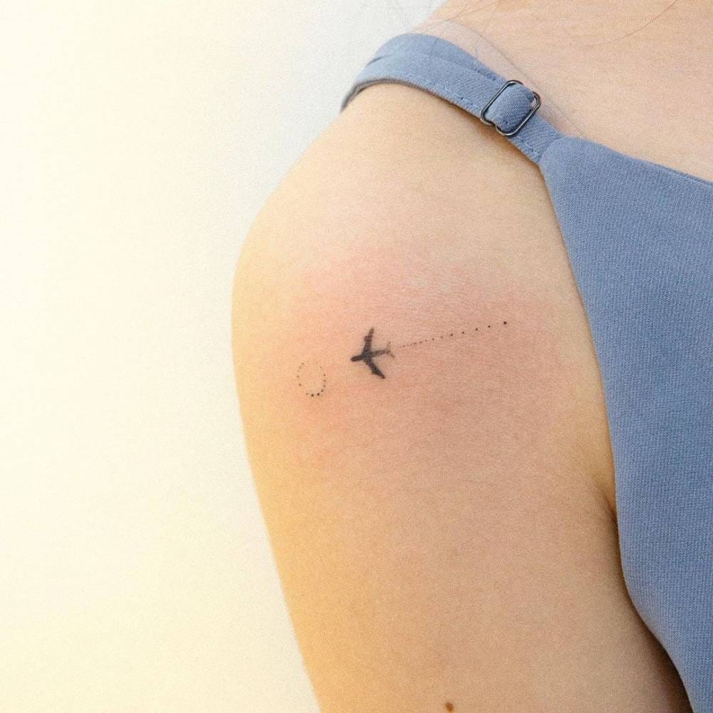 minimalist airplane tattoo