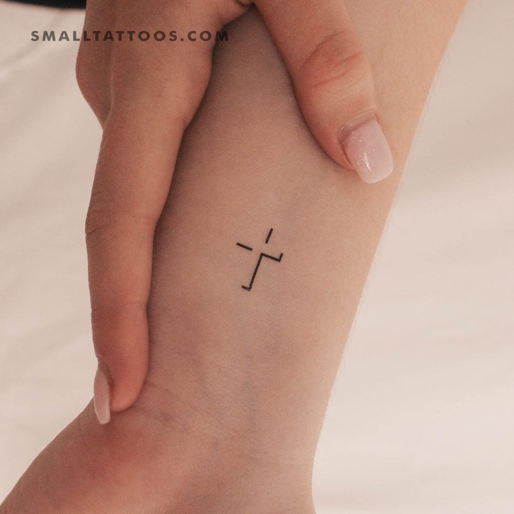 minimalist cross tattoo