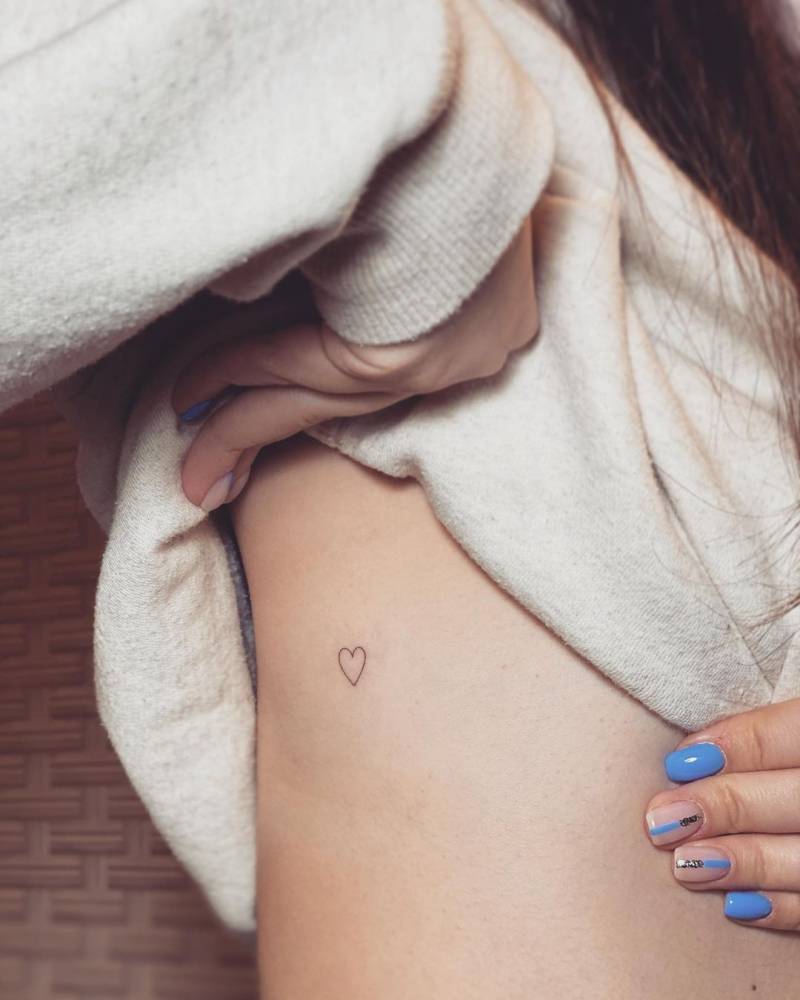 a rib tattoo with a simple heart outline
