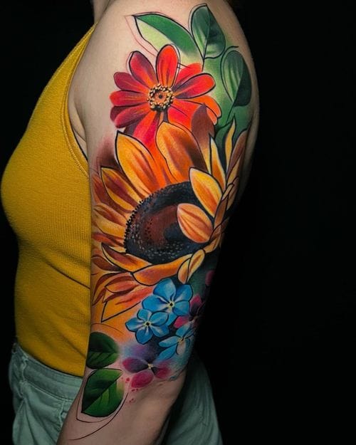 upper arm with vibrant watercolor floral tattoo
