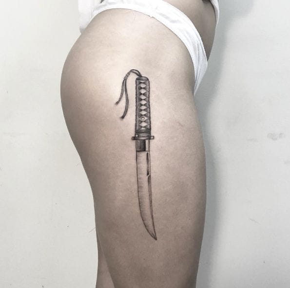 a small Japanese tattoo with a knife