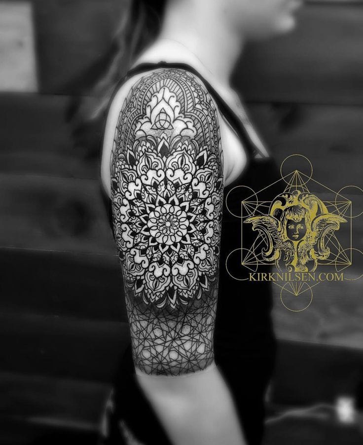 upper arm with intricate blackwork mandala tattoo