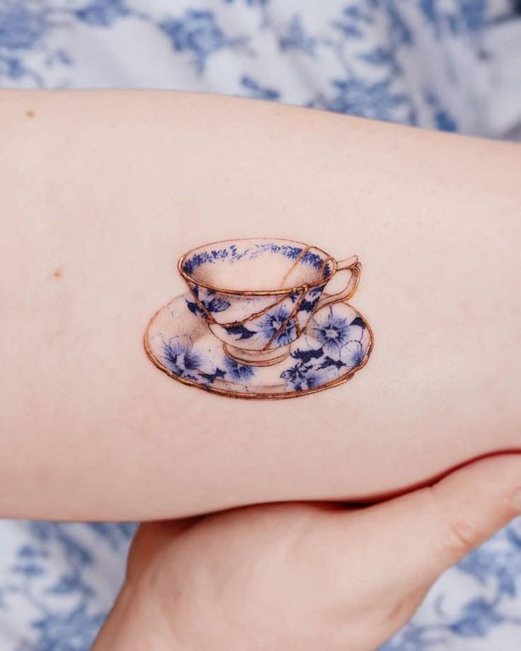 a small Japanese tattoo with a teacup