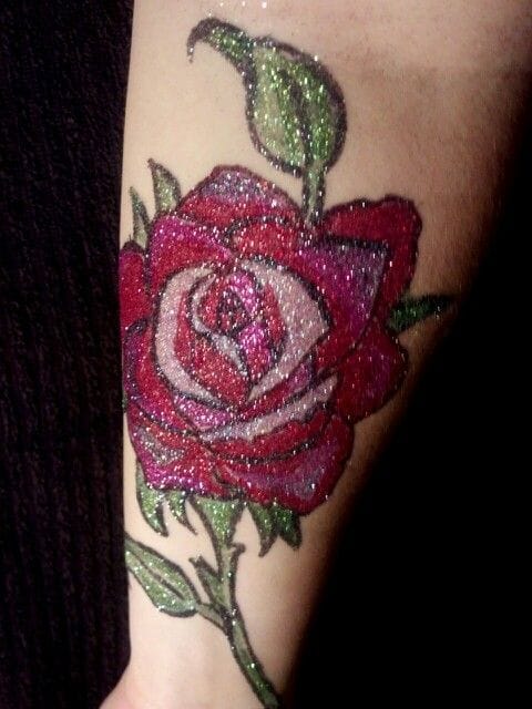 a dazzling glitter tattoo with a glitter rose