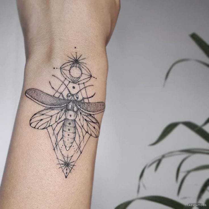 a unique firefly tattoo with negative space