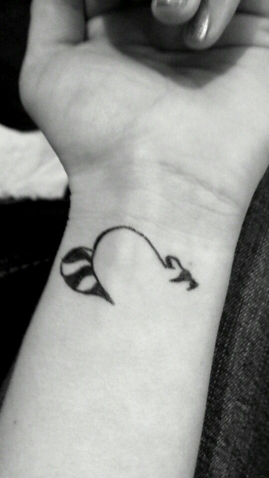heart raccoon tattoo