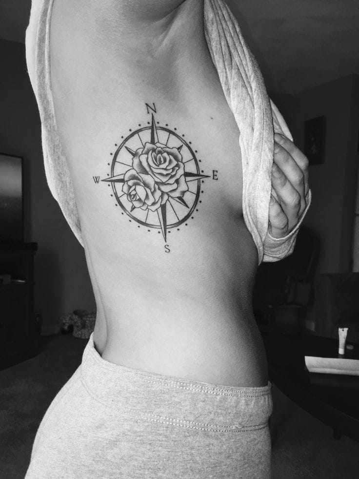 a rib tattoo with a compass rose