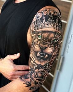 a muscular upper arm tattoo with king crown
