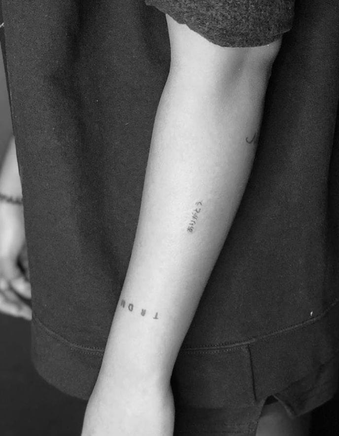 a small Japanese tattoo with a Kanji character