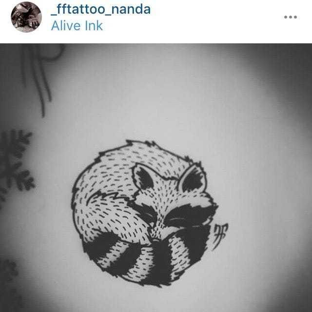 sleeping raccoon tattoo