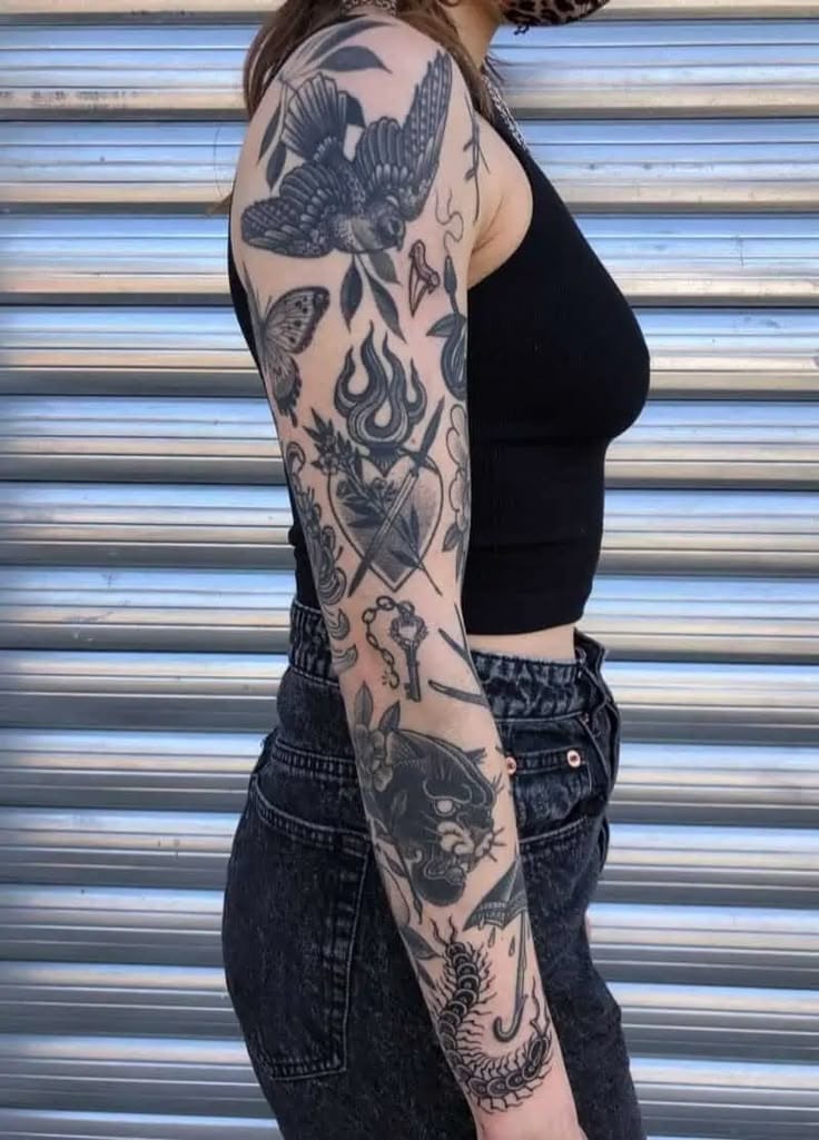 blackwork patchwork sleeve tattoo