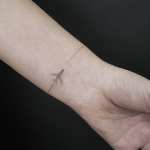 airplane on wrist tattoo