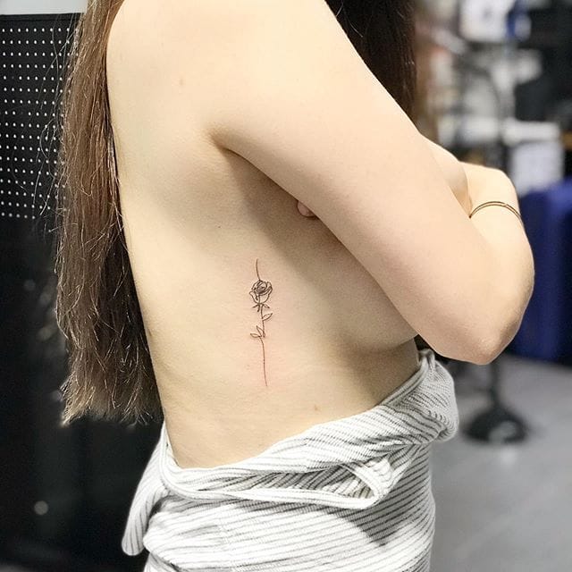 a ribs tattoo with single line flower