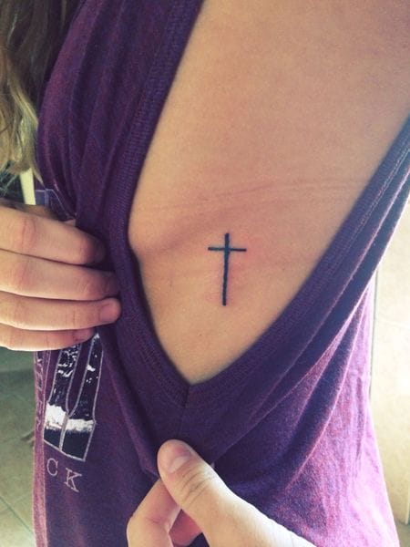 a beautiful ribs tattoo with a simple cross